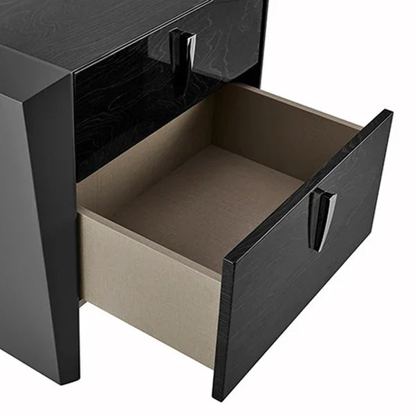 Black bedside table with open drawer showing wood grain finish and modern handles