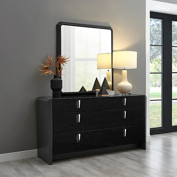 Black six drawer dresser with mirror, lamp, and decor against grey wall