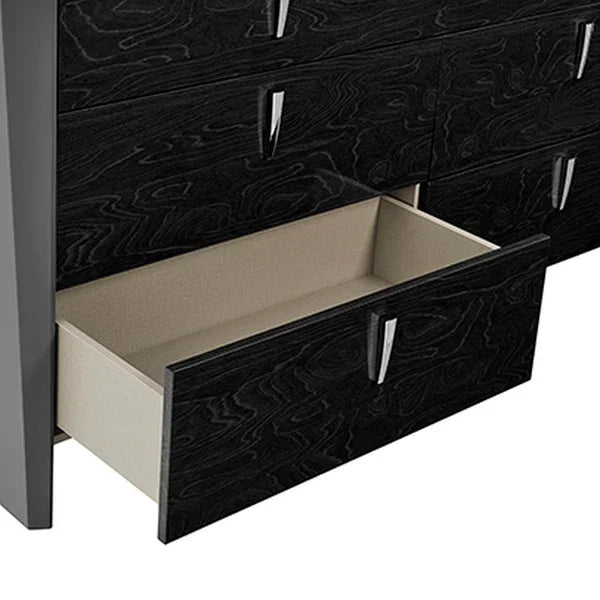 Black wood chest of drawers with metal handles, one drawer open showing storage space