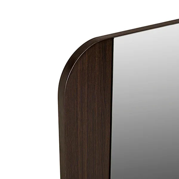 Closeup of dark wood framed mirror with rounded corner