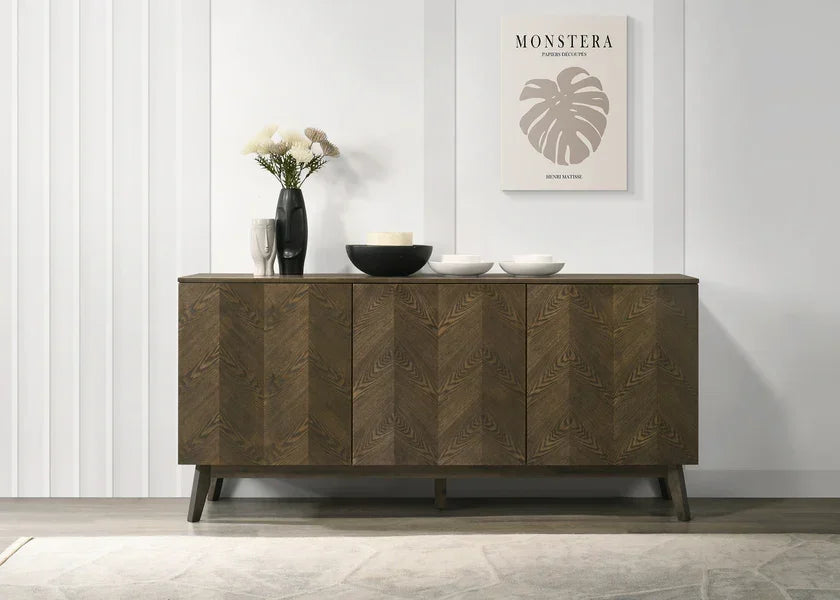 Chevron pattern wooden sideboard with decorative vases and bowls in modern living room