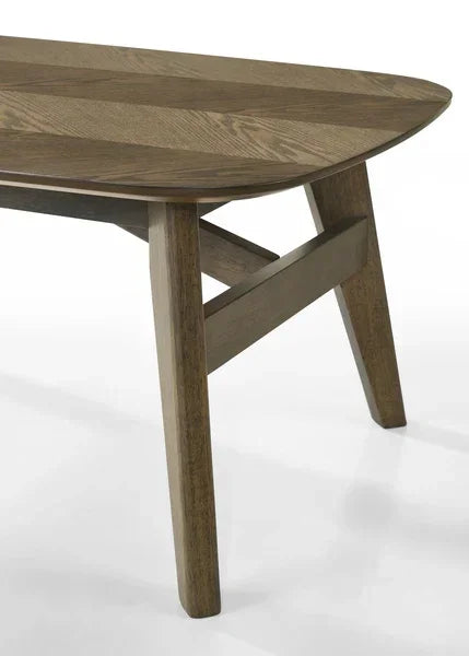 Oak wood dining table with angled legs and rounded edge, close-up of corner detail