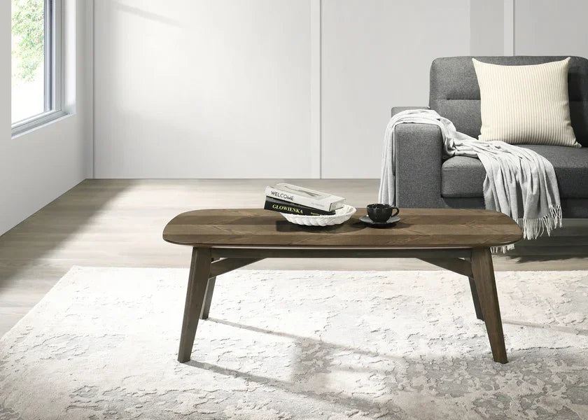 Walnut wood coffee table with books and cup in modern living room setting