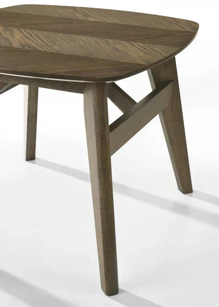 Wooden dining table with angled legs and visible wood grain, partial side view