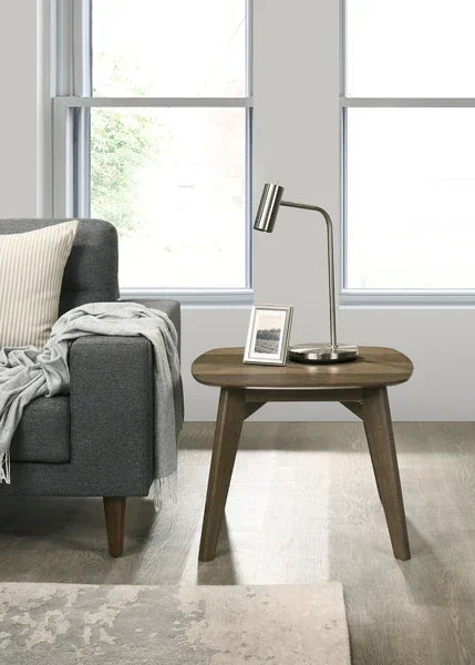 Wooden side table with modern lamp next to grey sofa in living room