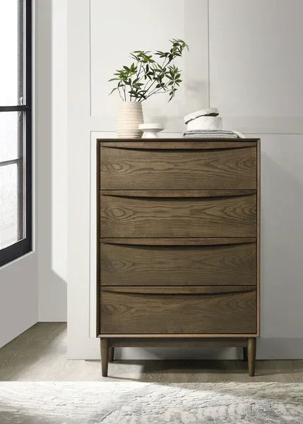 Tall wooden chest of drawers with four drawers and slim legs in modern bedroom