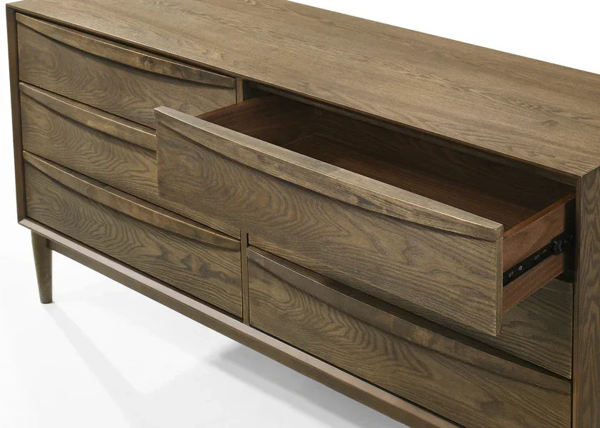 Oak wooden dresser with six drawers, one drawer open, angled side view