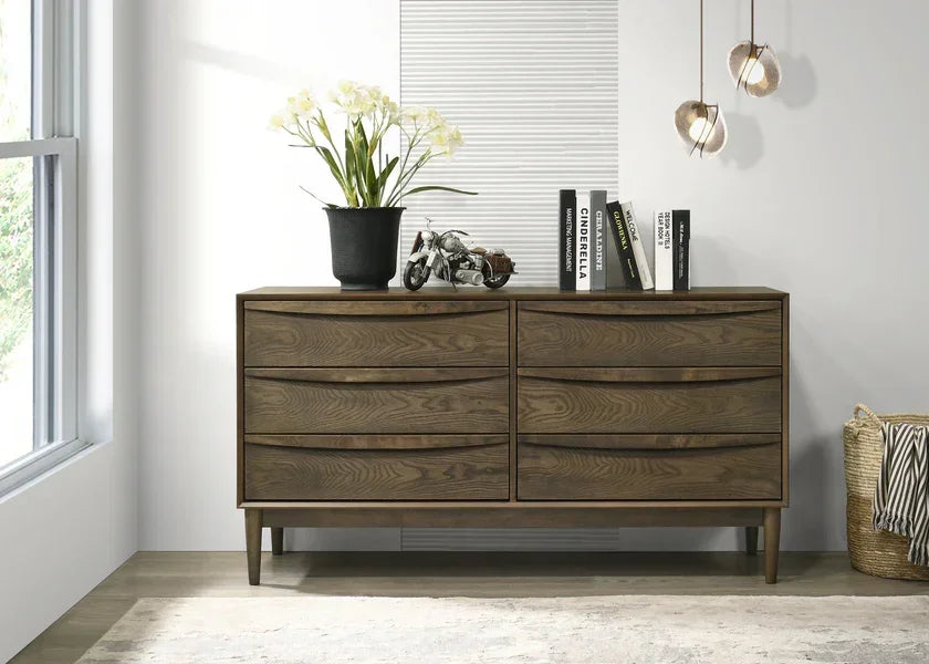 Modern oak sideboard with six drawers, decor, books and plant in bright living room