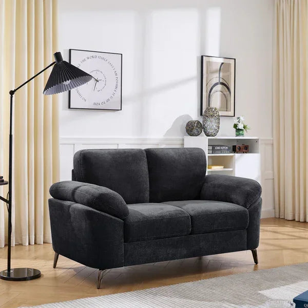 Charcoal grey fabric sofa with angled armrests in modern living room setting