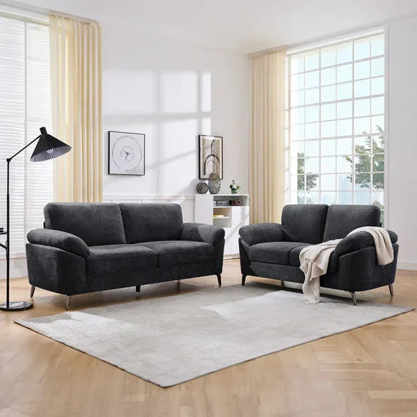 Dark grey fabric sofa set in modern living room with light rug and large windows