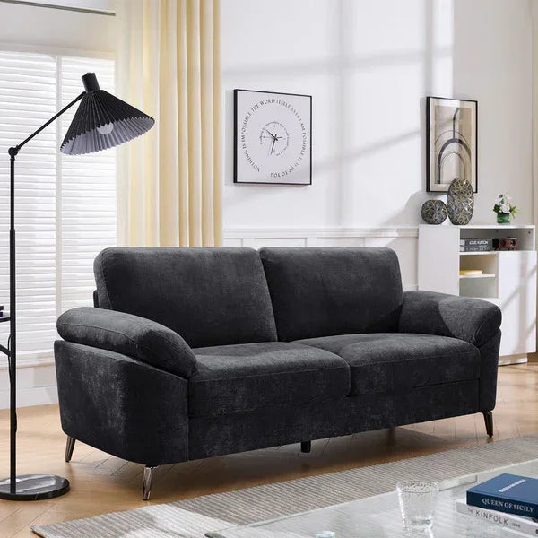 Charcoal fabric sofa with wide armrests in modern living room setting
