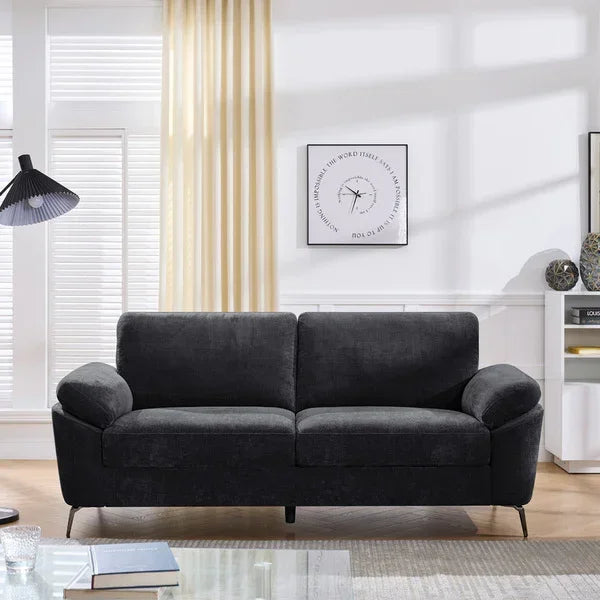 Charcoal fabric sofa with metal legs in modern living room setting
