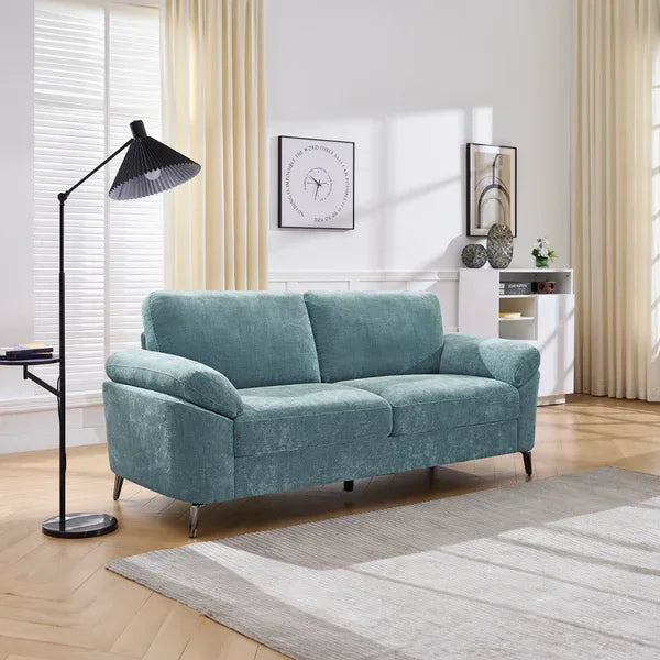 Light blue fabric sofa with curved armrests in modern living room setting