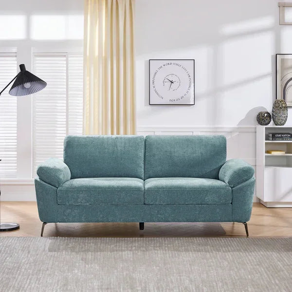 Light blue fabric sofa with metal legs in modern living room setting