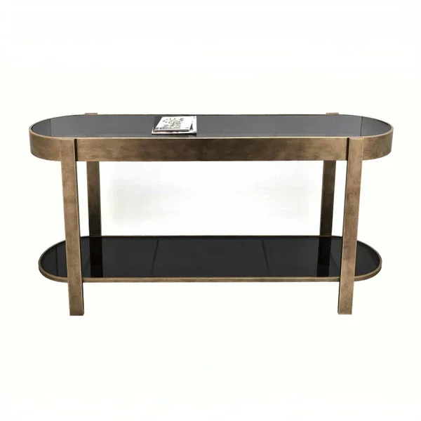 Gold metal and black glass console table with lower shelf and book on top