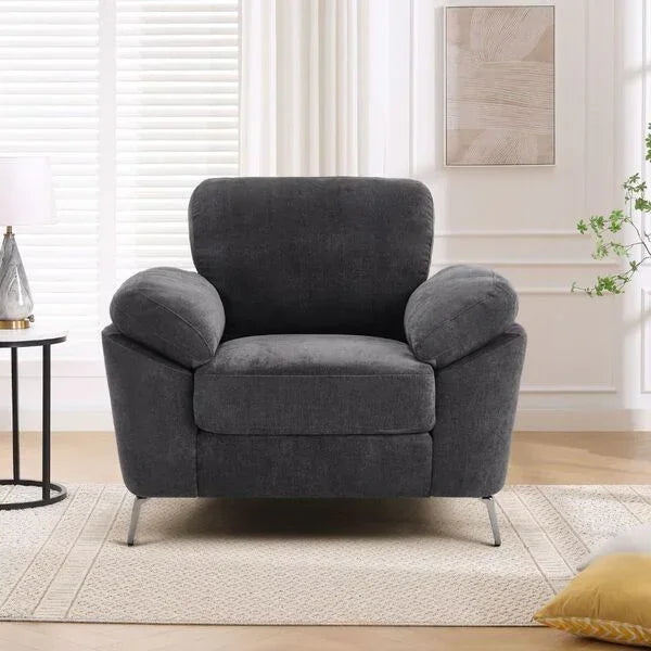 Charcoal fabric armchair with metal legs in a modern living room setting