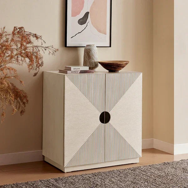 Modern sideboard cabinet with geometric doors in cream wood, styled in a living room corner