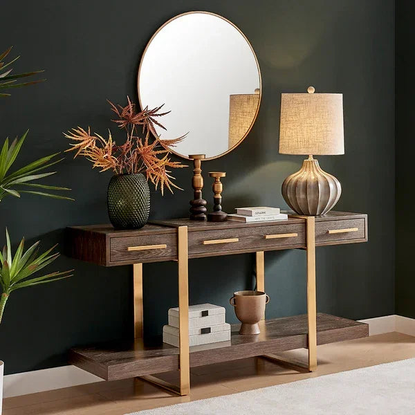 Modern console table with gold accents, table lamp, decorative vase and round mirror