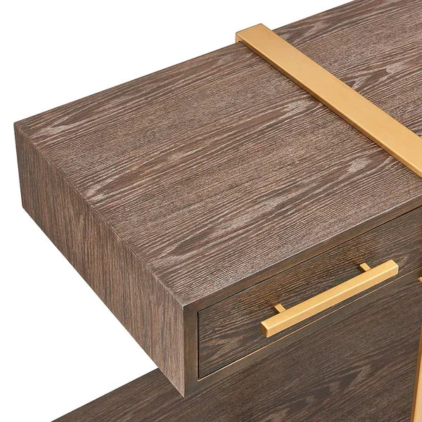 Closeup of console table in dark wood with a gold handle and decorative gold accent