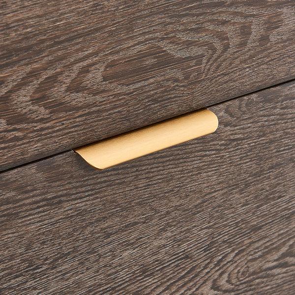 Close up of wood drawer with brushed gold handle, visible wood grain texture