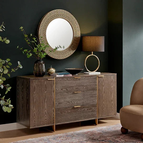 Modern sideboard with wood finish, gold accents, and decorative lamp in living room setting