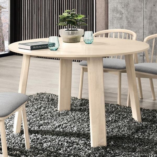 Light wood dining table with matching chairs on grey rug in modern dining room