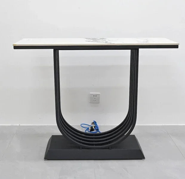 Modern console table with a rectangular marble top and black geometric metal base