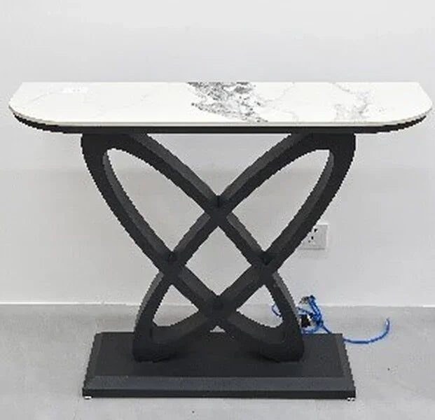 Marble top console table with black geometric base against a white wall