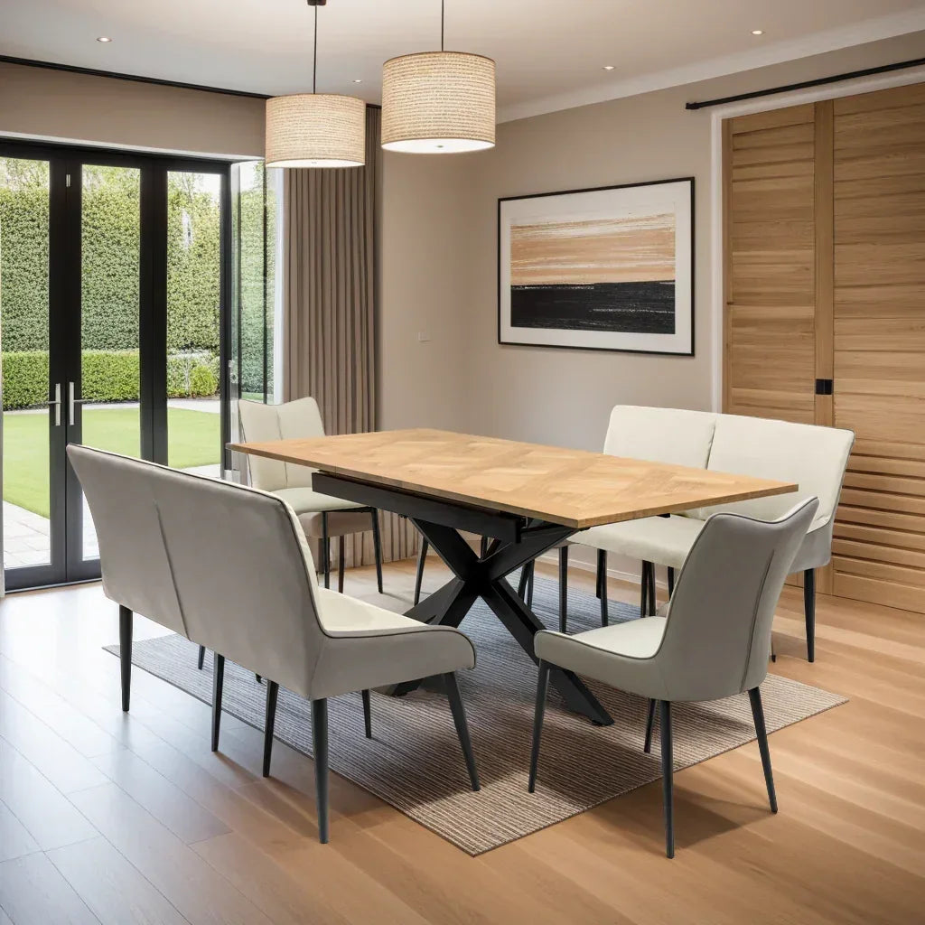 Modern wood and metal dining table with cream upholstered bench and chairs in bright room