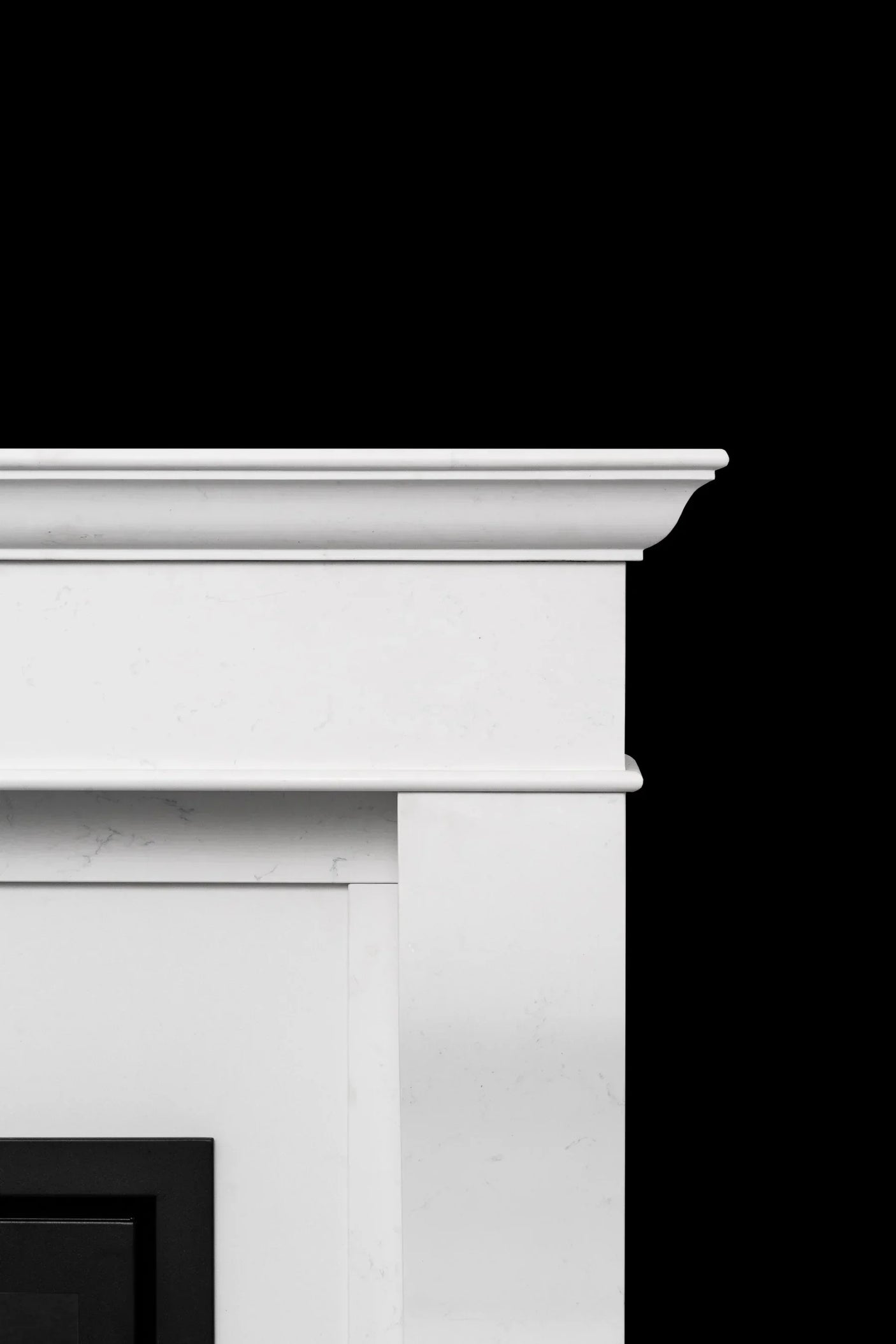 Close-up of white marble fireplace surround with classic moulded edge detail