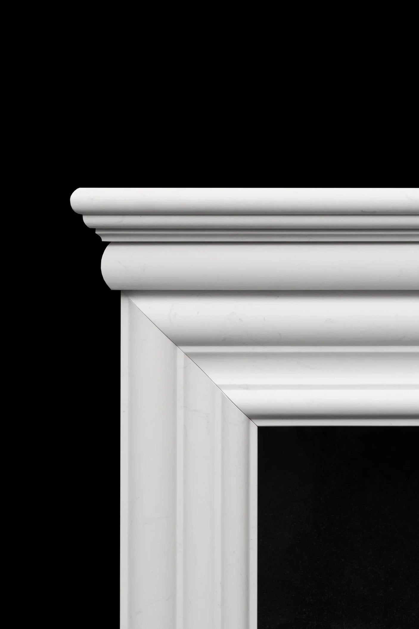 Close-up of white marble fireplace mantel with classic moulding details