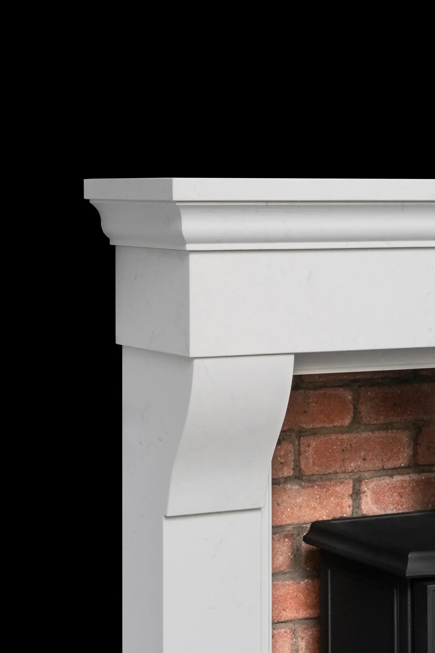White fireplace surround with classic molding and brick interior detail
