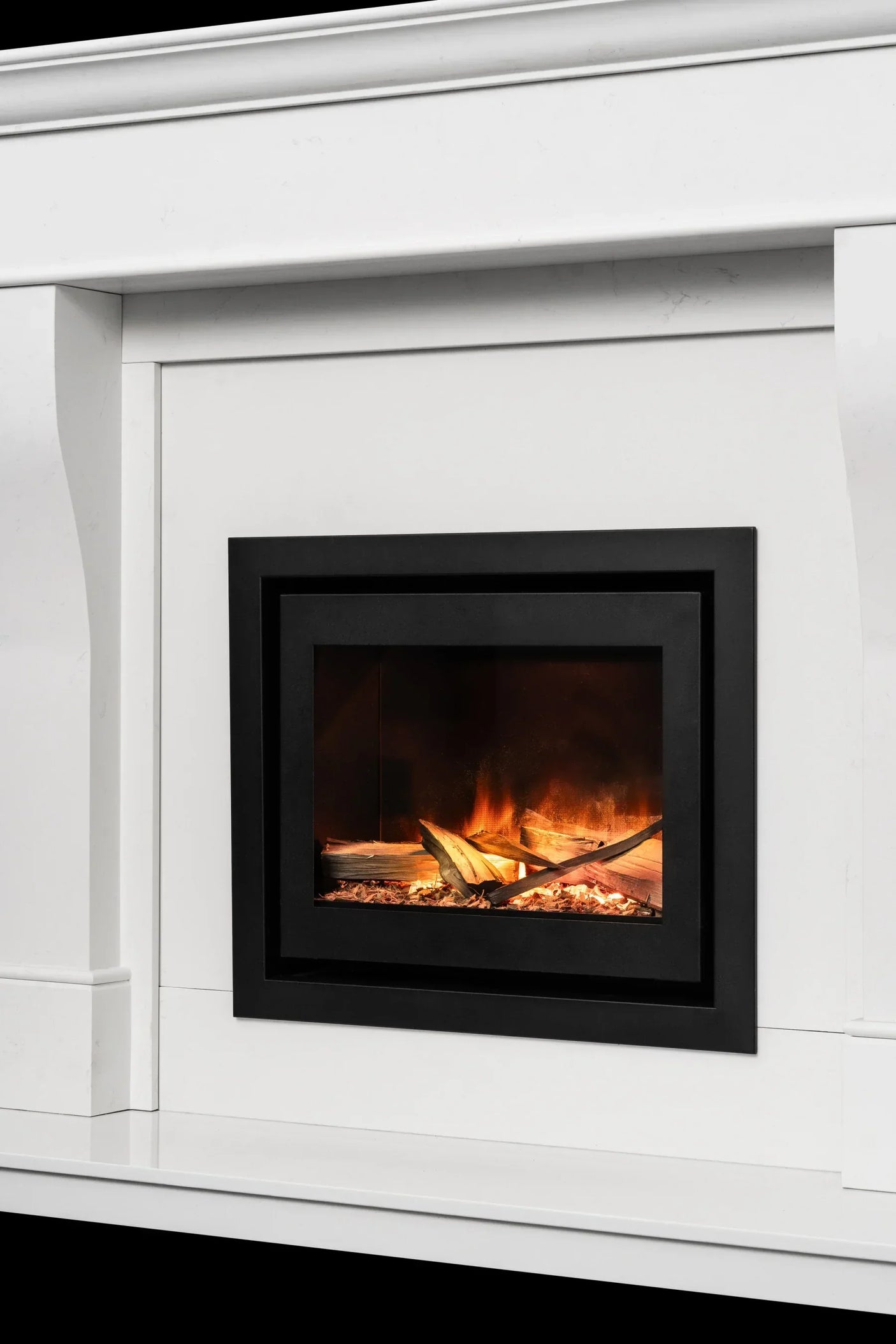 Electric fireplace with black frame set in white mantel, flame effect and log display