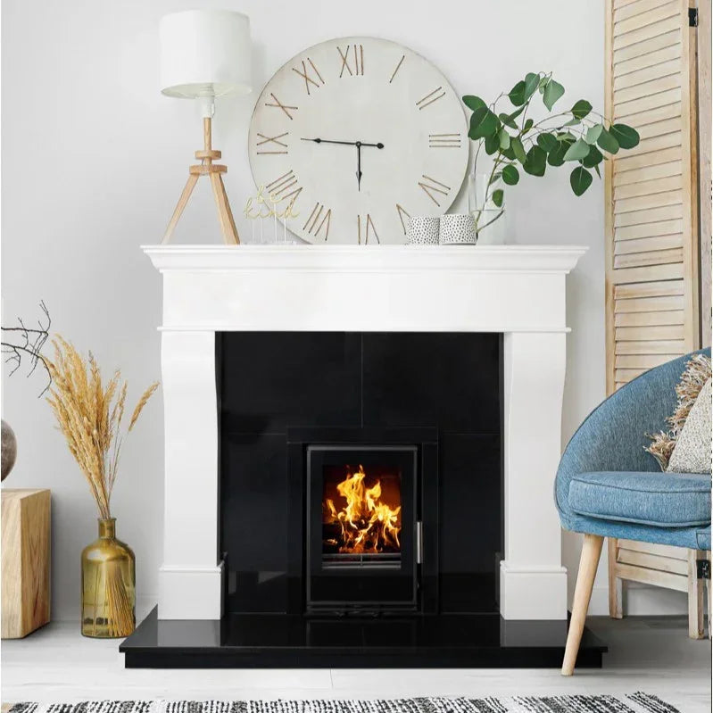 Polished polar white fireplace surround with black inset and lit fire in modern living room