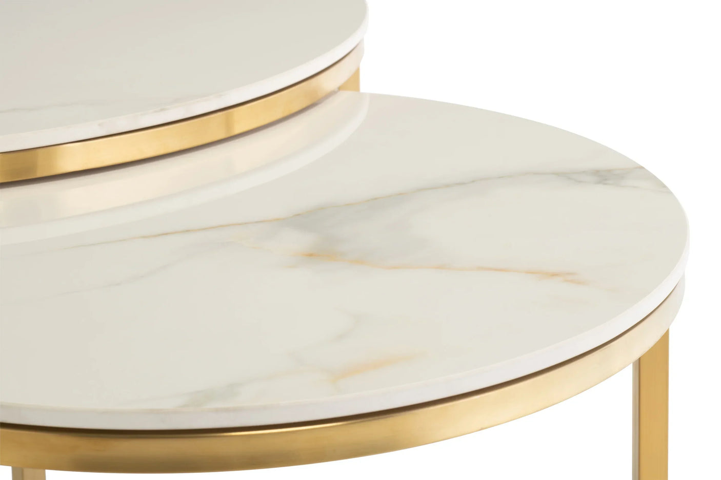Close-up of marble nesting table tops with gold metal frames