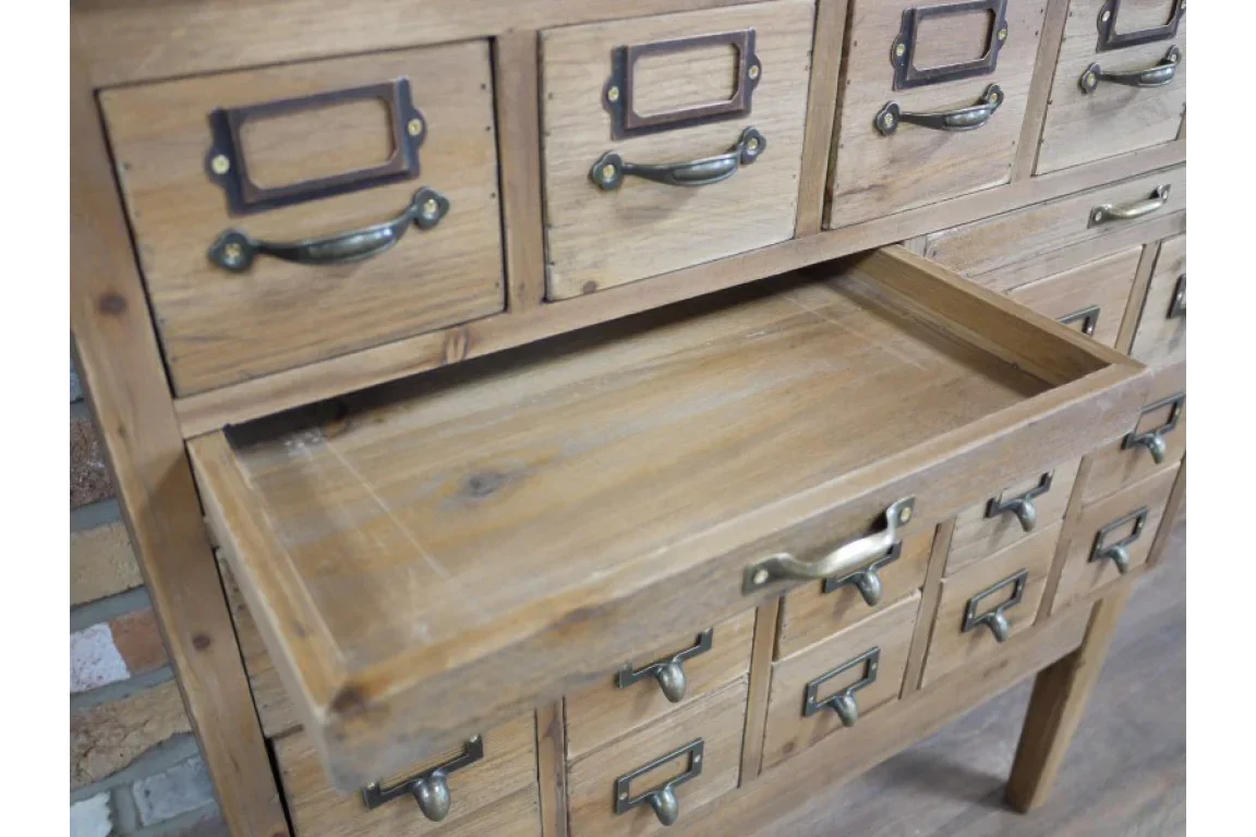 Wooden storage cabinet with multiple drawers and brass handles, one drawer open