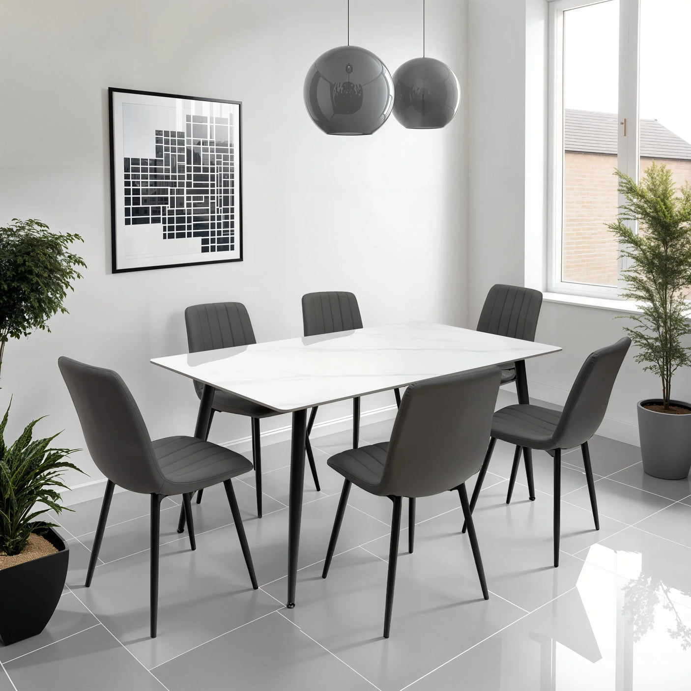 Grey dining chairs with black legs around a white dining table in modern dining room