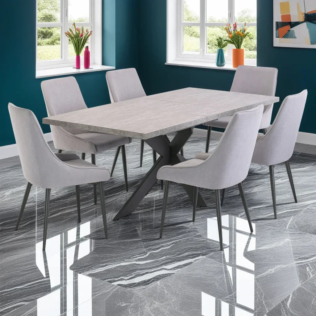 Rectangular stone top dining table with six grey upholstered chairs in modern dining room