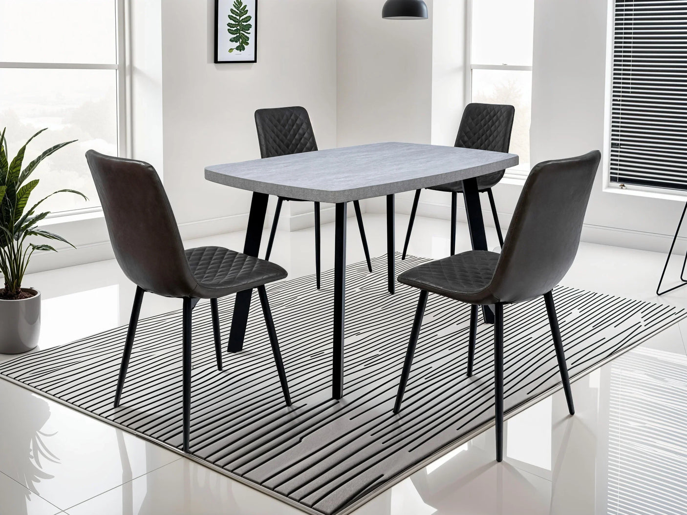 Modern dining table set with four black quilted chairs on striped rug in bright room