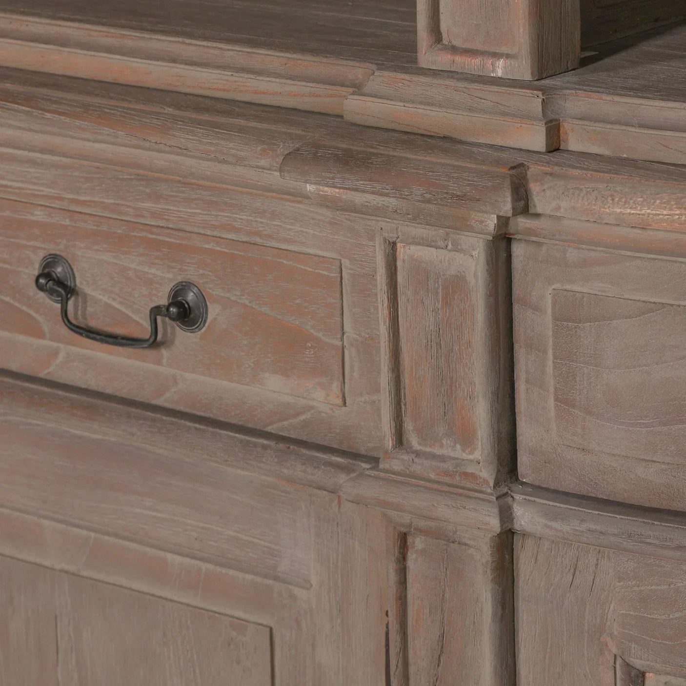 Rustic wood sideboard detail with drawer handle and panelled design