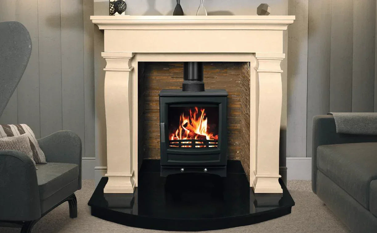 Black wood burning stove with flue in cream stone fireplace, modern living room setting