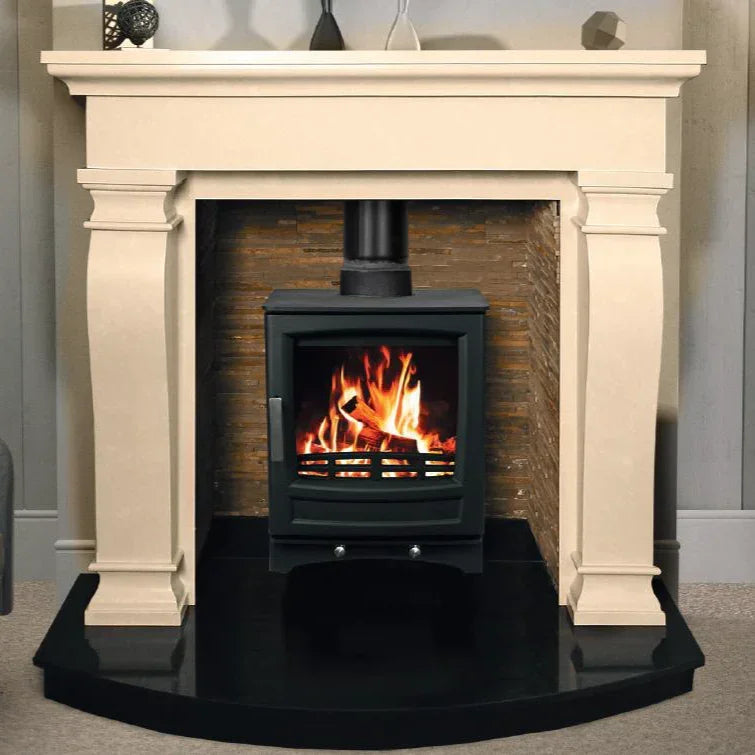 Black wood burning stove with fire set in cream mantel and tiled surround
