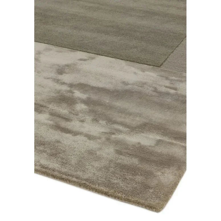 Modern beige and taupe area rug with subtle abstract pattern and soft texture closeup
