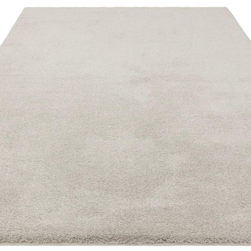 Light grey area rug with soft pile texture, shown from low angle