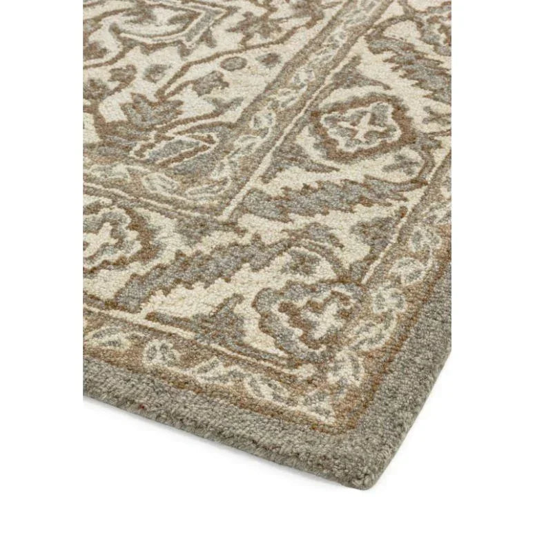 Corner of a neutral patterned rug with beige, grey, and taupe wool detailing