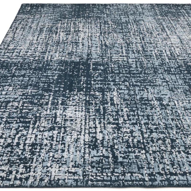 Blue and grey abstract area rug with textured modern pattern, shown from above
