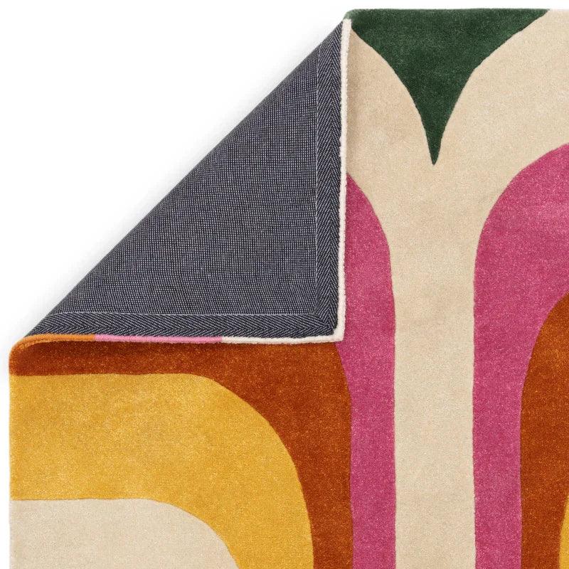 Multicolour abstract area rug corner fold showing backing and bold geometric pattern