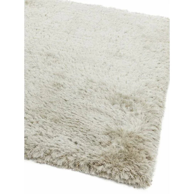 Closeup of soft cream shaggy rug corner with thick pile texture