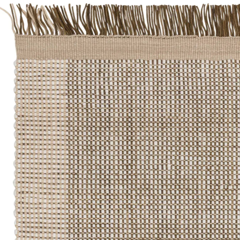 Beige woven rug with textured pattern and fringe edge, close-up of natural fibers