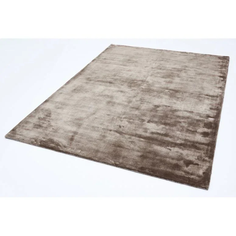 Large rectangular taupe area rug with soft velvet finish on a white background